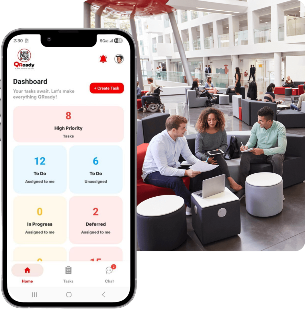 Smartphone task dashboard beside people collaborating in lobby