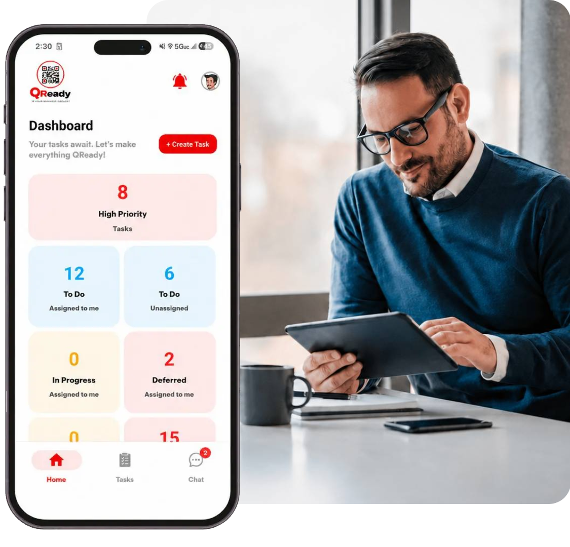 Person using tablet beside smartphone showing task dashboard