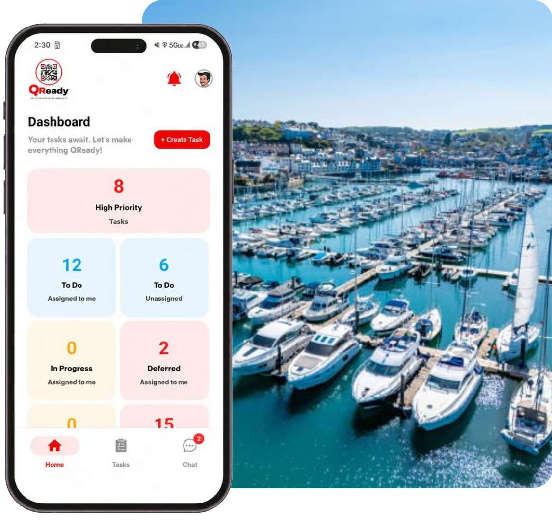 Smartphone showing task dashboard beside yacht marina